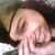 A person with dark hair and light skin covers their mouth with both hands, eyes closed, in a static pose with no visible text or background details.