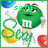 Green M&M character with 'm' logo on chest, holding yellow and red candies, standing against white background with blue cloud-like shapes.