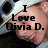 Pixelated image of a person's face with overlaid text reading "I Love Olivia D." against a blurred background.