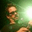 Pixelated figure with light skin tones and brown hair stands against a green gradient background, holding an object near the face.