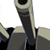 Static pixelated icon of a character's lower body and weapon, showing partial legs in dark pants with blue accents and a large curved sword or scythe-like blade.