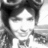 Black-and-white pixelated image of a person with dark hair, closed eyes, and a neutral expression, cropped to show upper body and head.