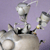 A pixelated static image of a grey pig-like character with a rounded body, small ears, and a long snout, standing against a solid light purple background.
