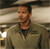 Static pixelated image of a person in military-style attire with a hat, set against an indistinct background.