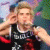 nine animated frames showing a person in a black sleeveless shirt with white trim, performing various gestures and expressions against a blurred background