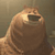 Pixelated brown bear-like figure with open mouth, light brown fur, and dark brown nose against muted background.