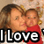 Static pixel art image of two people embracing, one in red clothing, with large bold text reading 'I Love' at the bottom.