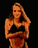 A woman with long blonde hair in a black bikini top poses against a black background, shifting her hands and arms
