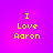 Four identical pixelated text arranged in a on a purple-to-pink gradient background, each displaying "I Love Aaron" in yellow block letters