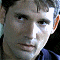 A 60x60 pixel animated contact sheet showing two frames of a buddy icon with a person's face on the left and green text reading "Original Icons .com" on the right against a dark background.