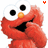 Two side-by-side pixelated images of a red muppet-like character with large white eyes, black pupils, and an orange nose, both smiling with hands near their faces.