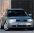 Static pixelated image of a light blue sedan with dark tinted windows, positioned at a three-quarter angle against a dark background with a light-colored vertical element on the left.