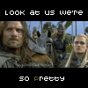 A static image of a character with long brown hair and a beard, wearing a green cloak, standing in front of a group of armored figures with a blue sky background.