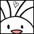 Pixelated static icon of a white cartoon character with black stick-figure limbs, small square eyes, and a pink mouth, featuring a heart symbol above its head on a transparent background.