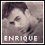 Pixelated portrait of a person with dark hair and light skin, featuring the name 'ENRIQUE' in white block letters at the bottom.