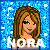 Pixelated image of a woman with brown hair and green eyes, wearing a strapless top against a blue starry background with the text "NORA" below her face.