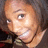 Pixelated close-up of a person's face with light skin tone, visible eye and mouth area showing teeth in a smile, dark background.