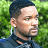 Pixelated image of a person with short dark hair and light skin, wearing a dark shirt against green foliage background; adjacent text reads 'Original Icons .com' in bright green pixel font on dark green.