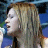 A pixelated contact sheet showing two frames of an animated icon featuring a woman with long blonde hair singing into a microphone on the left and green text reading "Original Icons .com" on a dark green background on the right.