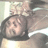 Pixelated image of a person with dark hair wearing a black top, lying down against a light background.