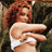 Pixelated static image of a woman with red hair wearing white bikini bottoms, standing against a dark green background.