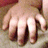 A hand with fingers spread on a textured surface, showing subtle variations in finger positioning across frames.