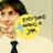 Pixelated image of a person with dark hair wearing a yellow shirt and black tie, holding a blurred object against light background.