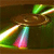 A pixelated image shows a brown wooden structure with green and white elements, including a colorful gradient cone shape on the left.