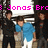 Pixelated image of four people standing together under a white sign with pink text reading "Jonas Bro".