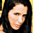 A 48x48 pixel animated contact sheet showing three sampled frames of a woman with long dark hair in different poses and expressions, arranged in a 2x2 grid with one empty gray cell.