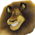 Pixelated cartoon lion head with brown mane, yellow face, blue eyes, and white teeth, smiling with closed mouth, set against dark brown background.