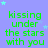 A static image with a light purple background displaying repeated green text "kissing under the stars with you" surrounded by small light blue stars.