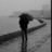 Black-and-white image of a person walking away on a wet road with red text overlay expressing memory loss and love.