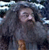 Pixelated static image of a character with dark hair and light skin, wearing a gray top against a blue-toned background with white highlights.