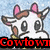 A cartoon cow with pink ears and brown patches on its head, wearing a yellow scarf against a light blue background.