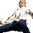 Pixelated static image of a person in motion with visible facial features, white shirt, dark pants, and partial background elements.