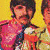 Four men with mustaches pose against a yellow background; two wear red-and-white striped shirts, one wears blue and white stripes, another pink. The lower-left section shows a cropped view of the same scene.