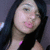 Pixelated close-up of a person with dark hair, pink lips, and light skin wearing a black top with a small purple accent.