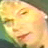 Pixelated close-up of a person's face with closed eyes, warm yellow and orange tones dominating the image.