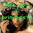 A pixelated image of a person with curly hair wearing a crown, with green text above and below the head.