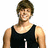 A person in a black tank top with changing text on the chest, smiling against white background.