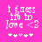 Pixelated pink background with white text reading "i guess i'm in love <3" and five heart symbols below, where the third heart is lighter than the others.