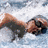 A pixelated image shows a person lying on a beach with arms raised, overlaid with blue text reading "GO AQUA TRAINS!!!" against a wave background.