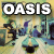 Pixelated static image featuring large white text "OASIS" at the top over a blurred background with abstract shapes and colors including blue, purple, green, yellow, and black.
