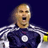 Pixelated static image of a person in sports attire with an open mouth, likely shouting or cheering, against a dark blue background.