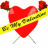 Red heart-shaped object with yellow banner reading 'Be My Valentine' and red roses on top, displayed in a