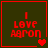 Red pixelated text "I LOVE AARON" on dark green background with red border, four variations of heart symbols in bottom-right corner.