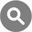Gray circular icon with white magnifying glass symbol centered on dark gray background.