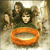 A static image of a person holding an orange ring with a blurred background of people and light.