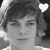 Black-and-white pixelated image of a person with short hair, two heart symbols above the head in one frame, and no hearts in another frame.